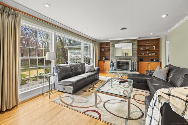 181 Picketts Ridge Rd, Redding, CT 06896 - living room featuring crown molding, light wood-style flooring, a large fireplace, built in features, and recessed lighting