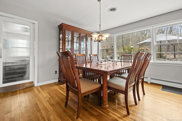 181 Picketts Ridge Rd, Redding, CT 06896 - dining area featuring a chandelier, wood finished floors, and baseboards