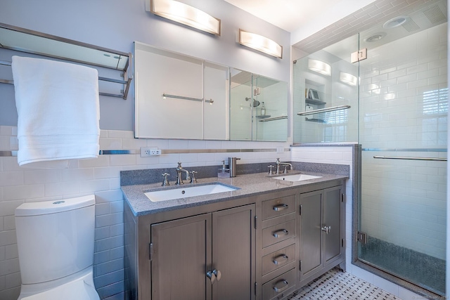 181 Picketts Ridge Rd, Redding, CT 06896 - full bathroom featuring a stall shower, toilet, double vanity, and tile walls