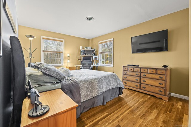 181 Picketts Ridge Rd, Redding, CT 06896 - bedroom featuring wood finished floors, multiple windows, and baseboards
