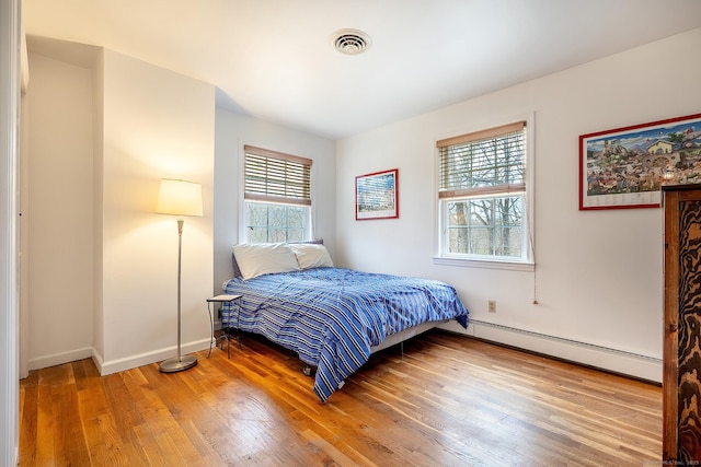 181 Picketts Ridge Rd, Redding, CT 06896 - bedroom with baseboard heating, light wood finished floors, and baseboards