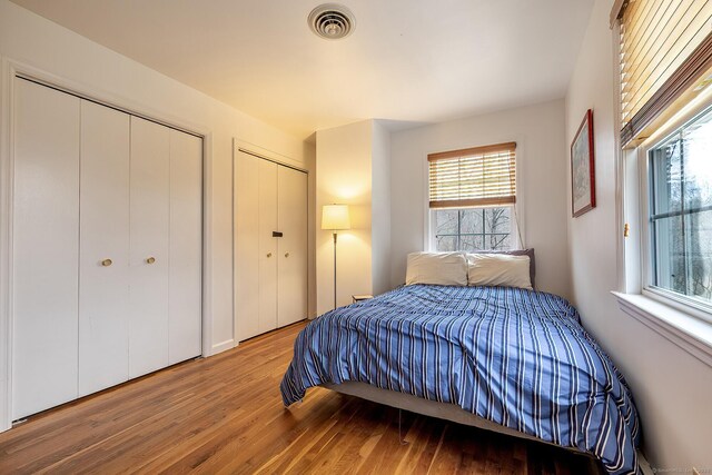 181 Picketts Ridge Rd, Redding, CT 06896 - bedroom featuring two closets and hardwood / wood-style flooring