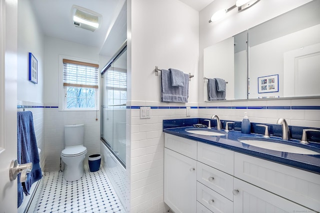 181 Picketts Ridge Rd, Redding, CT 06896 - bathroom featuring tile walls, tile patterned floors, a wainscoted wall, toilet, and double vanity