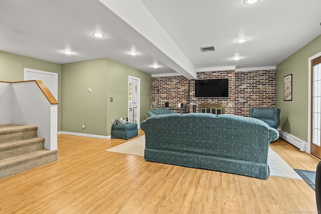 181 Picketts Ridge Rd, Redding, CT 06896 - living area featuring brick wall, baseboard heating, wood finished floors, stairs, and baseboards