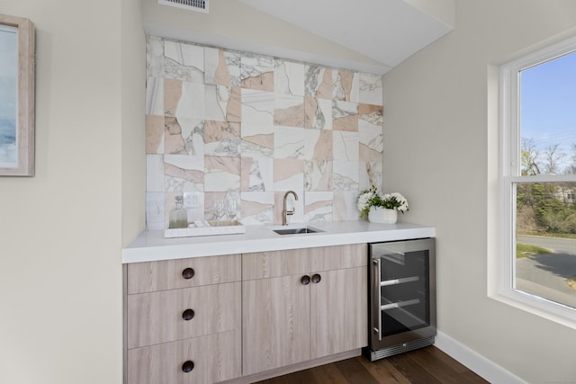 bar featuring indoor wet bar, a sink, wine cooler, and plenty of natural light
