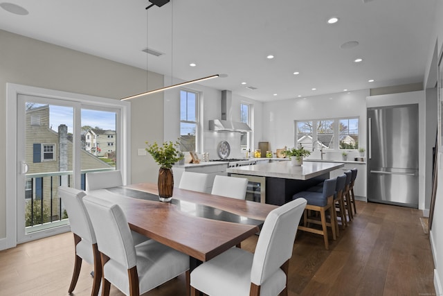 dining room with light wood finished floors, visible vents, and recessed lighting