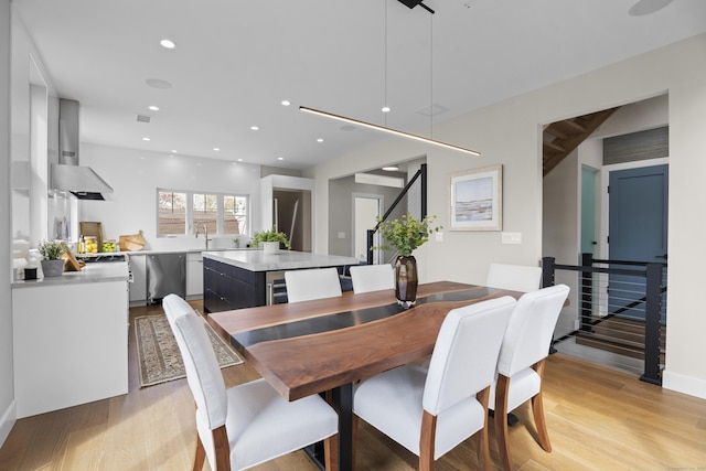 dining space with recessed lighting, light wood-style flooring, and visible vents