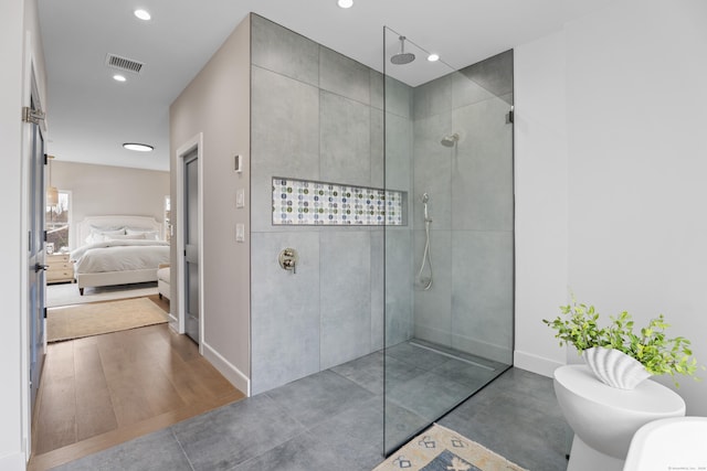 ensuite bathroom with recessed lighting, visible vents, connected bathroom, a walk in shower, and baseboards