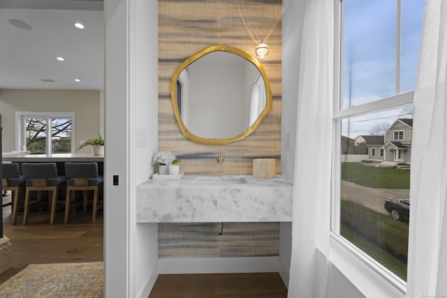 details with recessed lighting, wood finished floors, baseboards, and a sink