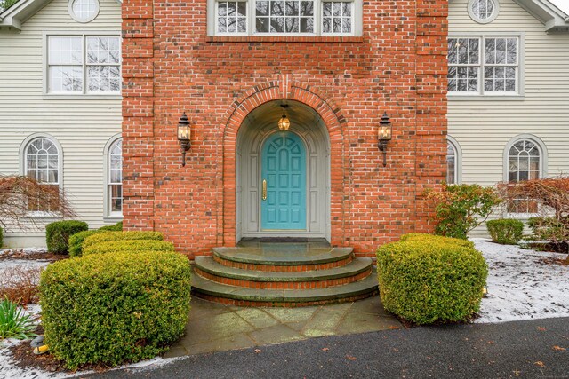 view of exterior entry with brick siding