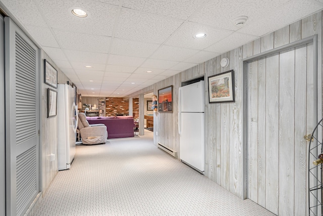 corridor with carpet floors, recessed lighting, and a drop ceiling