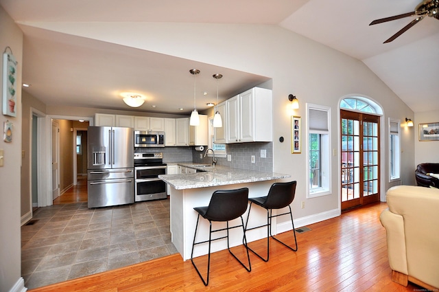 5 Middle Dr, Windsor Locks, CT 06096 - kitchen featuring stainless steel appliances, vaulted ceiling, open floor plan, a peninsula, and a breakfast bar area