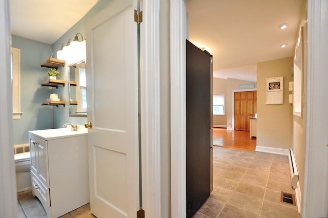 5 Middle Dr, Windsor Locks, CT 06096 - hallway with healthy amount of natural light, a baseboard radiator, and recessed lighting