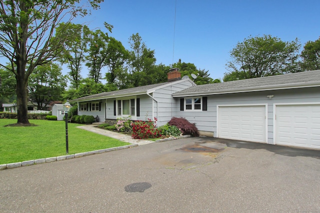 15 Old Stream Ln, Trumbull, CT 06611 - single story home with asphalt driveway, a chimney, a front yard, and a garage