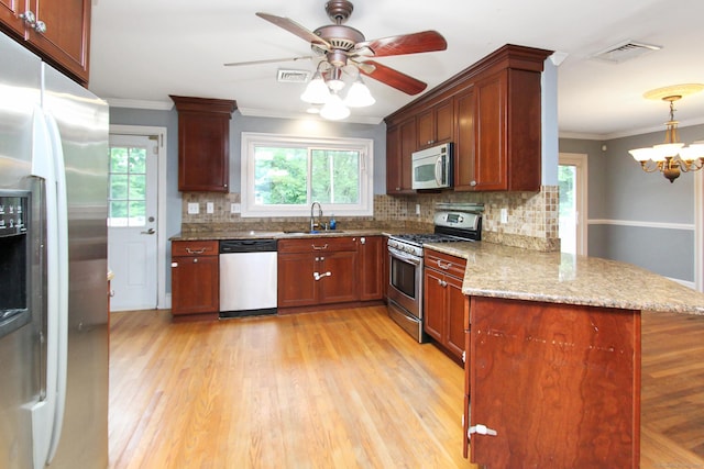 15 Old Stream Ln, Trumbull, CT 06611 - kitchen with stainless steel appliances, a peninsula, ornamental molding, tasteful backsplash, and light stone counters