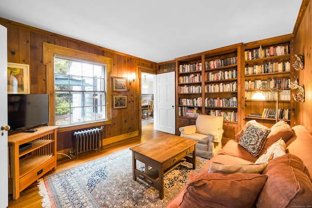 64 Blake Rd, Hamden, CT 06517 - living area with radiator, wood walls, and wood finished floors