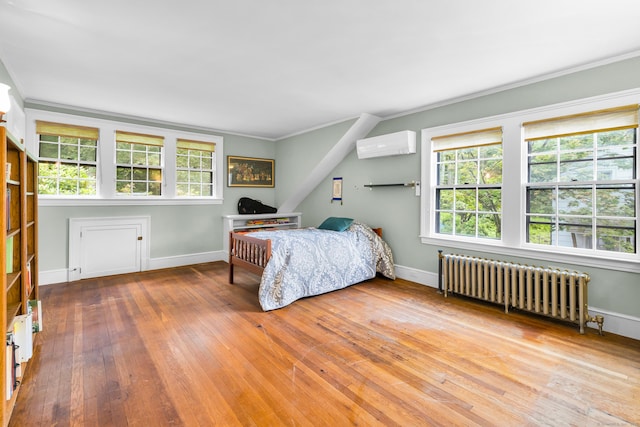 64 Blake Rd, Hamden, CT 06517 - bedroom featuring radiator heating unit, a wall mounted air conditioner, ornamental molding, and wood-type flooring