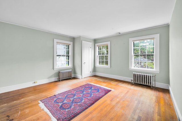 64 Blake Rd, Hamden, CT 06517 - empty room featuring radiator, hardwood / wood-style flooring, and ornamental molding