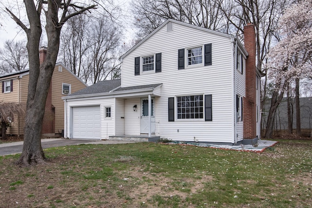 traditional home with an attached garage, a chimney, driveway, and a front lawn