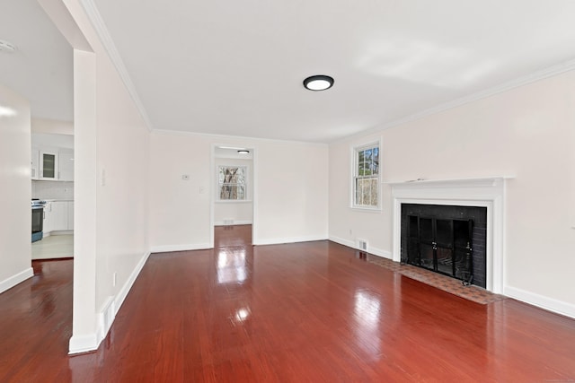 unfurnished living room featuring dark wood-style flooring, baseboards, a fireplace with flush hearth, and crown molding
