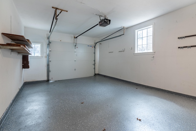 garage with a garage door opener and baseboards