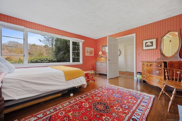 27 Wilbur Rd, Stonington, CT 06378 - bedroom with wallpapered walls, wood finished floors, and a baseboard radiator