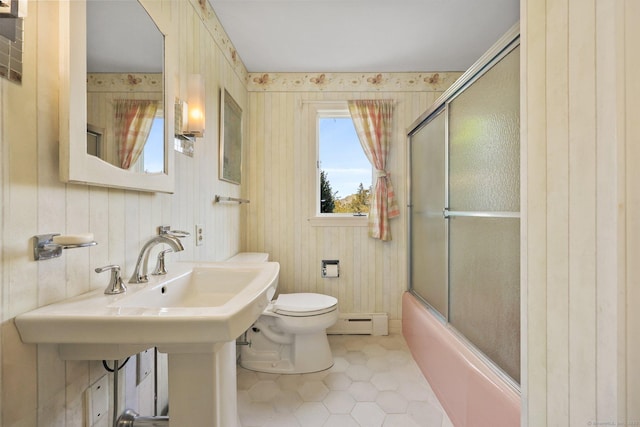 27 Wilbur Rd, Stonington, CT 06378 - full bath with a baseboard heating unit, tile patterned flooring, toilet, shower / bath combination with glass door, and a sink