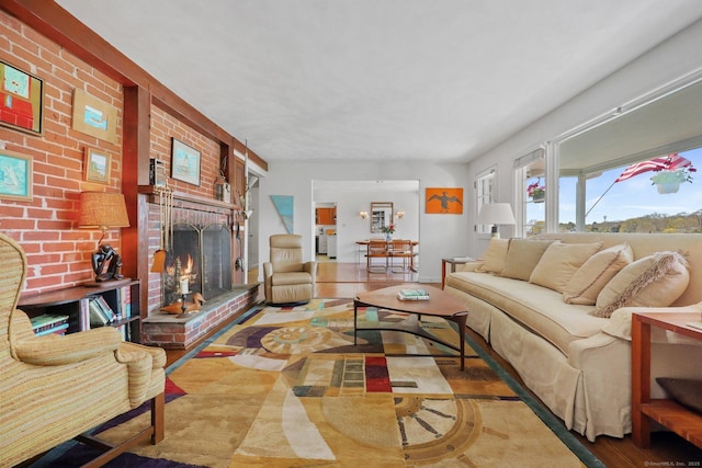 27 Wilbur Rd, Stonington, CT 06378 - living area with a brick fireplace and wood finished floors