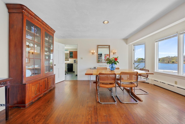 27 Wilbur Rd, Stonington, CT 06378 - dining area featuring hardwood / wood-style flooring, a water view, baseboards, and recessed lighting