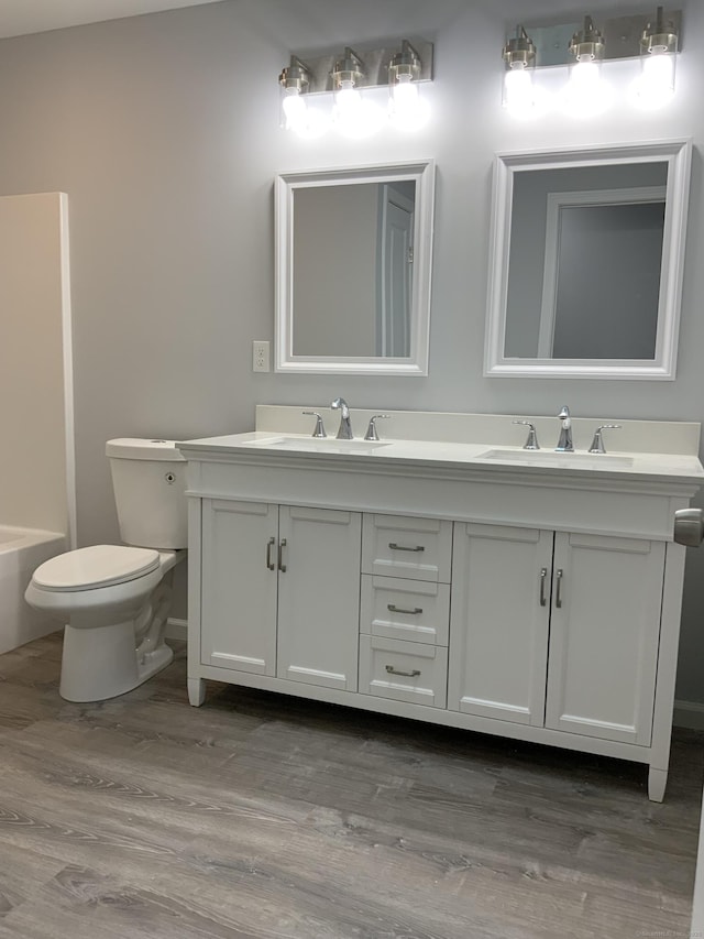 155 Peabody St, West Haven, CT 06516 - bathroom featuring toilet, wood finished floors, double vanity, and a sink