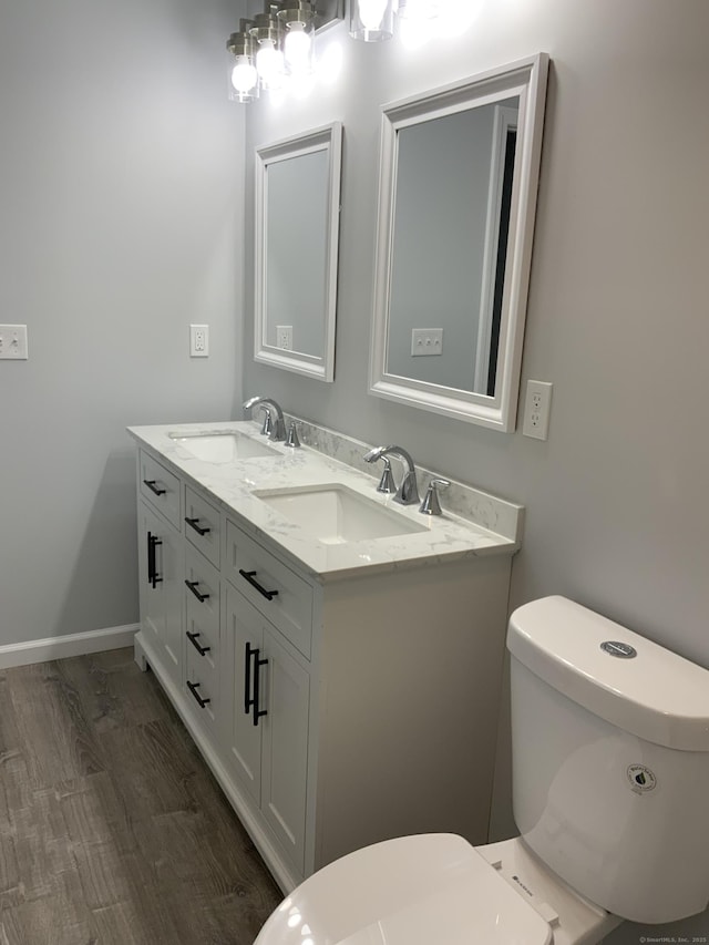 155 Peabody St, West Haven, CT 06516 - bathroom with toilet, double vanity, a sink, and baseboards