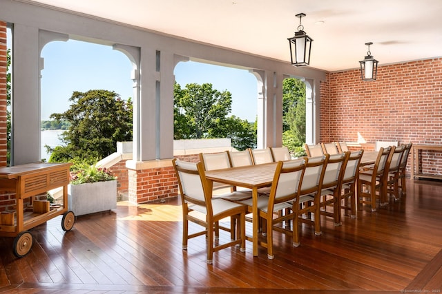 Rogers Is, Branford, CT 06405 - dining area featuring hardwood / wood-style flooring and brick wall
