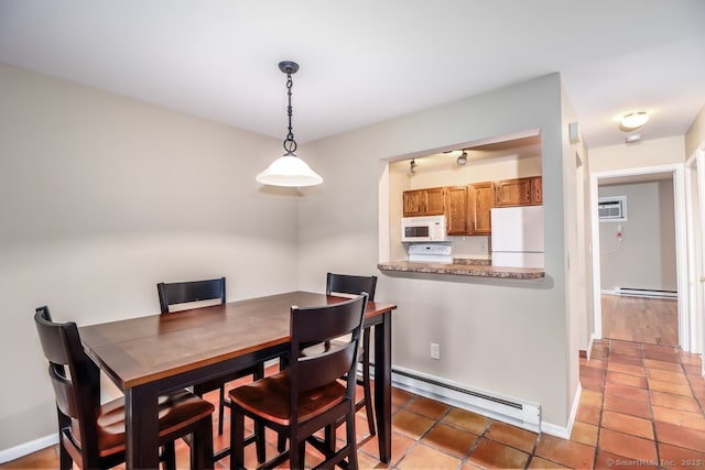 dining area with tile patterned floors, a baseboard heating unit, baseboards, and baseboard heating