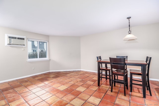 dining room with baseboards, a wall mounted AC, and light tile patterned flooring