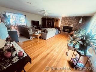 2780 Meriden Waterbury Tpke, Southington, CT 06444 - living room with a ceiling fan, wood finished floors, and a fireplace