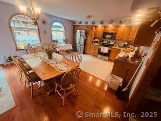 2780 Meriden Waterbury Tpke, Southington, CT 06444 - dining room featuring a notable chandelier and light wood-style flooring
