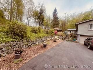 2780 Meriden Waterbury Tpke, Southington, CT 06444 - view of yard featuring a garage and aphalt driveway