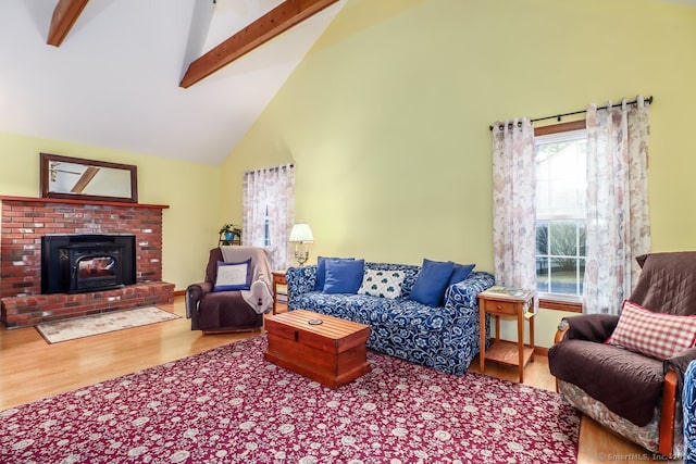 living area featuring wood finished floors, beamed ceiling, and high vaulted ceiling