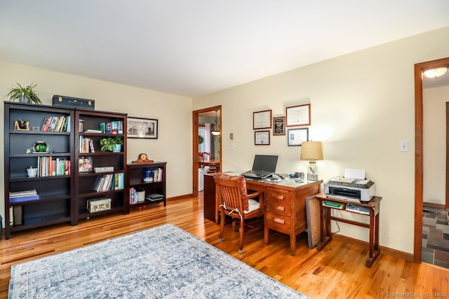 office featuring baseboards and wood finished floors