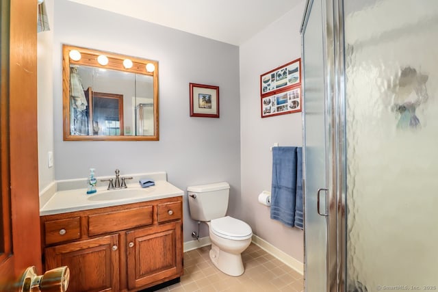 full bathroom with vanity, a stall shower, baseboards, and toilet