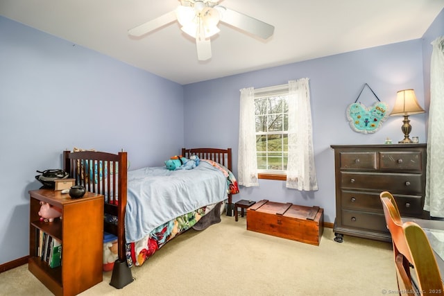 carpeted bedroom featuring baseboards and a ceiling fan