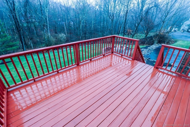 wooden terrace with a lawn