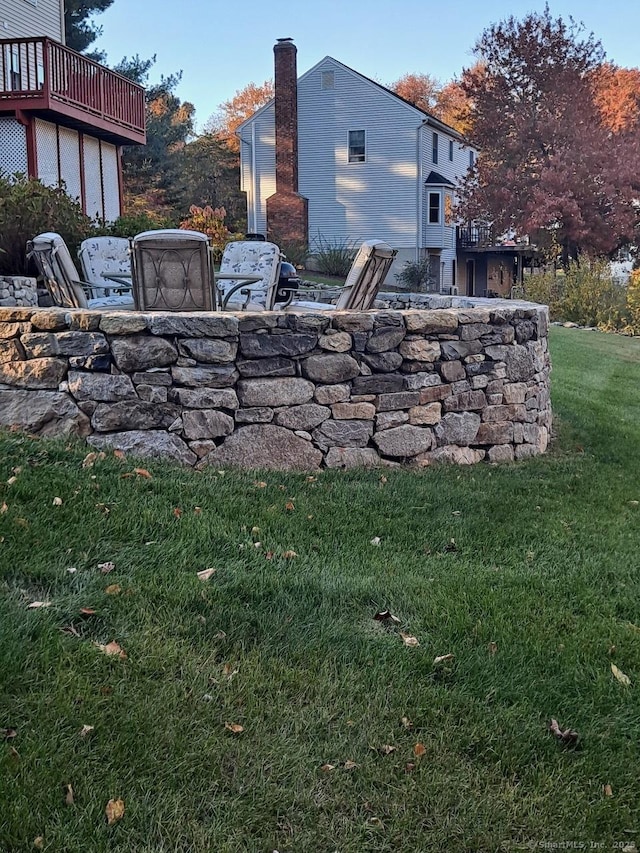 entry to storm shelter with a yard and a patio area