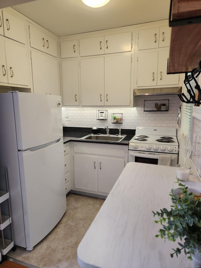 kitchen featuring white appliances, a sink, backsplash, dark countertops, and white cabinetry