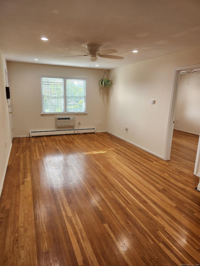 spare room with hardwood / wood-style flooring, a ceiling fan, recessed lighting, baseboards, and a baseboard radiator