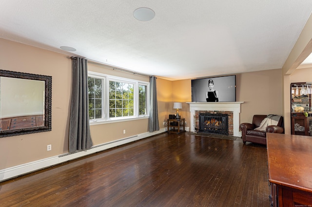 173 Barlow Mountain Rd, Ridgefield, CT 06877 - living room with wood-type flooring, a brick fireplace, and a baseboard radiator