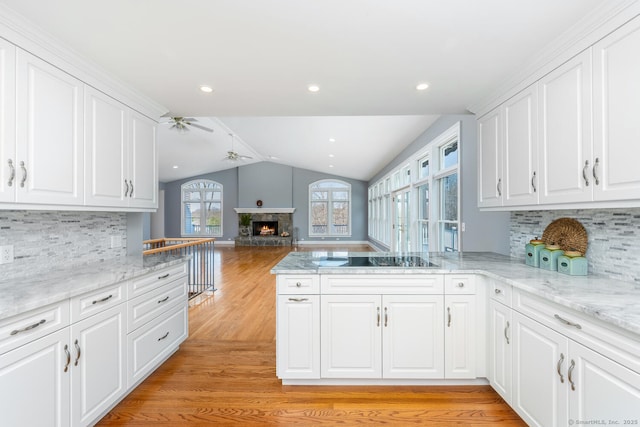 186 Isinglass Rd, Shelton, CT 06484 - kitchen featuring light wood-style floors, black electric cooktop, white cabinetry, a ceiling fan, and vaulted ceiling