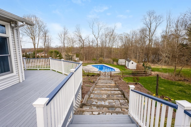 186 Isinglass Rd, Shelton, CT 06484 - deck with a storage shed, an outbuilding, a fenced in pool, a yard, and stairs