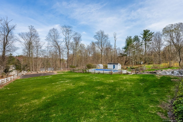 186 Isinglass Rd, Shelton, CT 06484 - view of yard with an outdoor structure, a shed, a covered pool, and fence