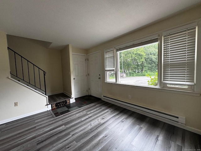 148 Westbury Park Rd Apt D, Watertown, CT 06795 - foyer entrance featuring a baseboard radiator, wood finished floors, stairs, and a textured ceiling